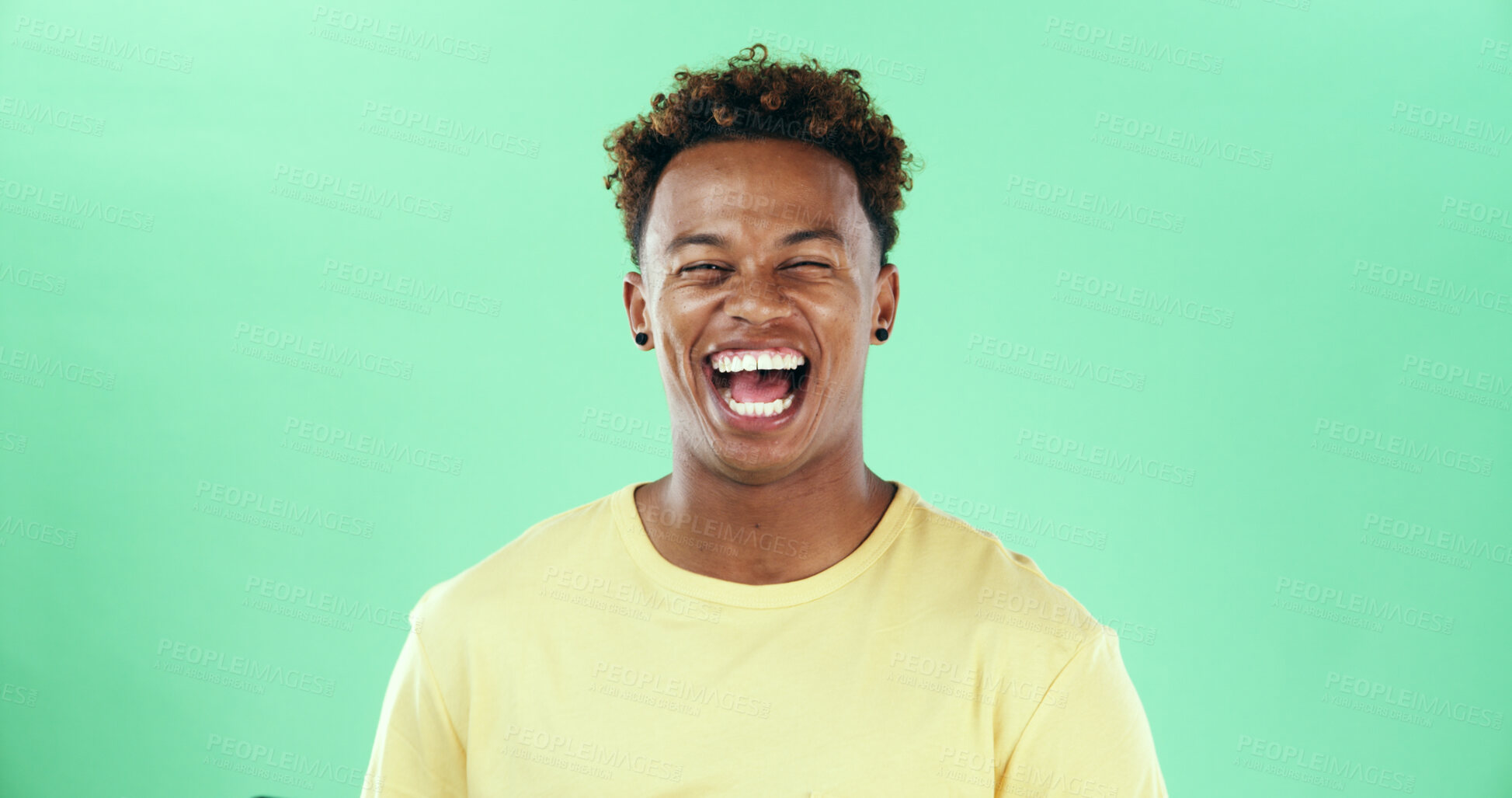 Buy stock photo Comic, funny or laughing with black man on green background in studio for humor, joke and meme. Face, smile and comedy with happy African student, model and reaction with positive emotion and joy