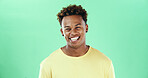 Comic, funny and smile with black man on green background in studio for humor, joke and meme. Portrait, laugh and comedy with happy African student, model and reaction with positive gesture and joy
