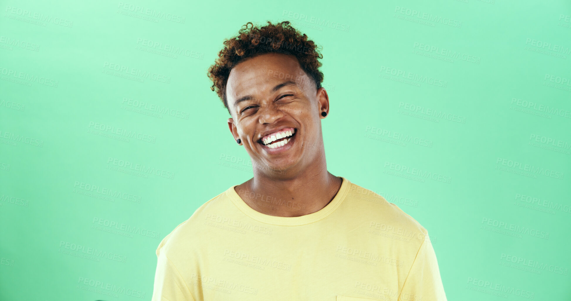 Buy stock photo Comic, laugh and smile with black man on green background in studio for humor, joke and meme. Face, funny and comedy with happy African student, model and reaction with positive emotion and joy