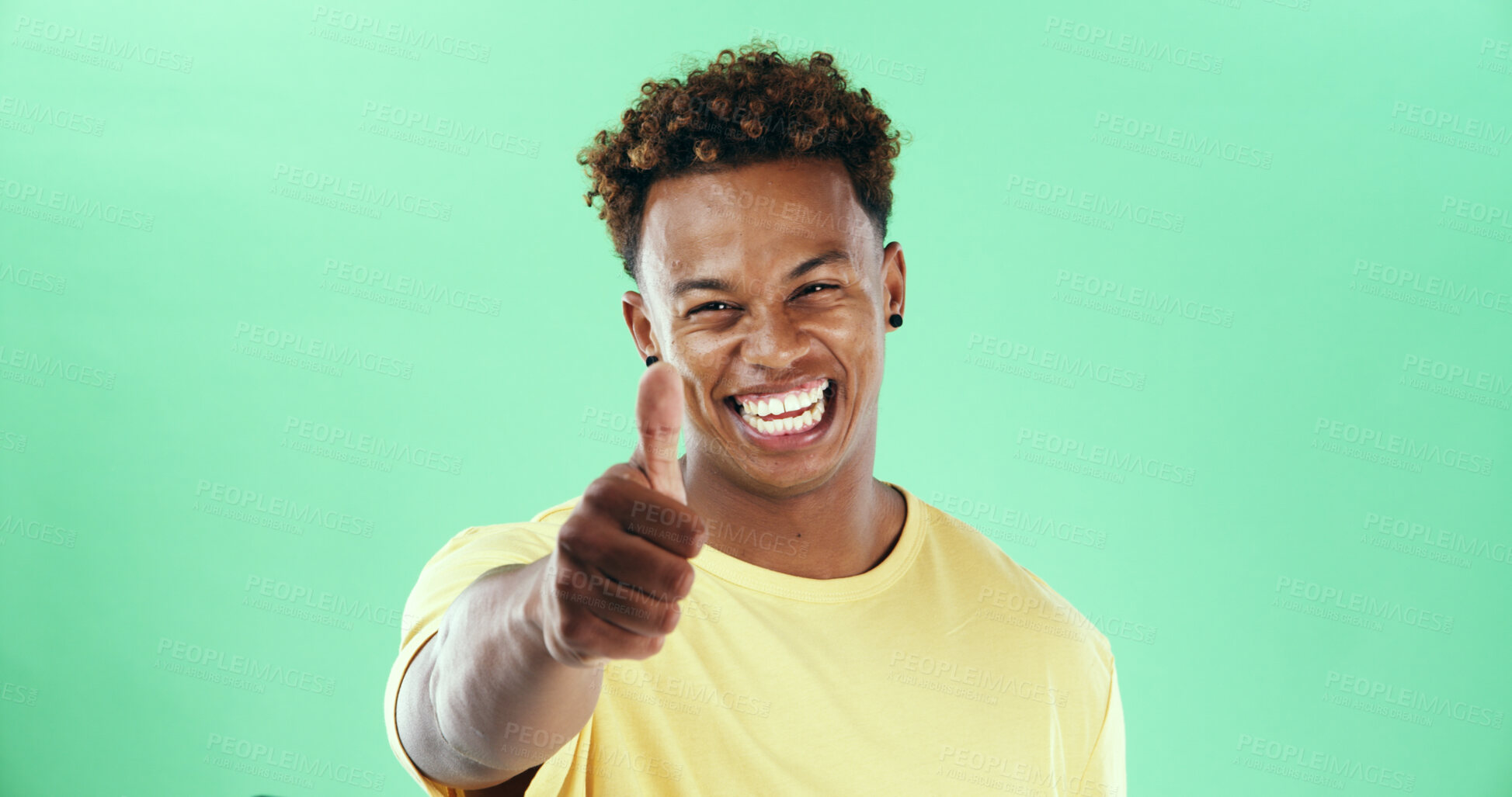Buy stock photo Portrait, thumbs up and black man in studio with yes, thank you and winning hand sign on green background. Winner, smile and model isolated with gesture for support review, success or good job emoji
