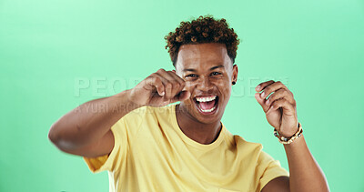 Buy stock photo Excited, dance and black man with portrait, music and comedy with smile in studio. Isolated, green background and happy male model with celebration, energy and freedom with hip hop for weekend fun