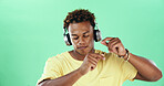 Calm black man, headphones and dancing on green screen with music, mockup space and wellness. Good mood, song audio and African male model in celebration with rhythm, zen energy and streaming sound
