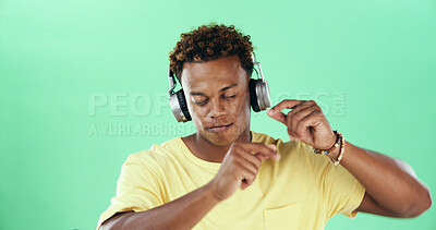 Buy stock photo Calm black man, headphones and dancing in studio on green background with music or wellness. Mock up space, song audio and African male model listening with rhythm, energy and streaming sound