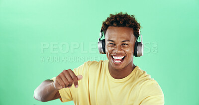 Buy stock photo Black man, portrait and dancing on green background with music, mockup space and smile. Headphones, song audio and excited model in studio celebration with rhythm, positive energy and streaming sound