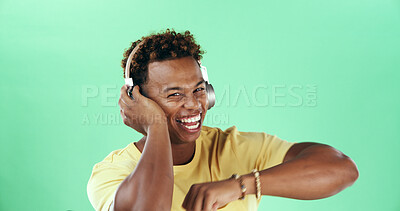 Buy stock photo Portrait, headphones and black man on green background with dancing music, mockup space or song. Studio, audio or excited model with smile to celebrate with rhythm, positive energy or streaming sound