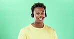 Talking, headset and african man in studio for call center, telemarketing and green background. Lead generation, telesales and happy male agent for sales, inbound marketing and networking by space