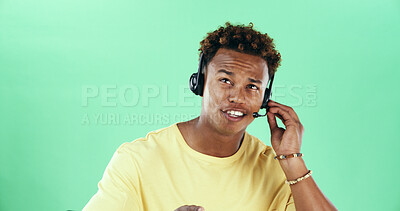 Buy stock photo Thinking, headset and african man in studio for call center, customer service and green background. Contact us, technical support and happy agent for help desk, troubleshooting and inquiry by space