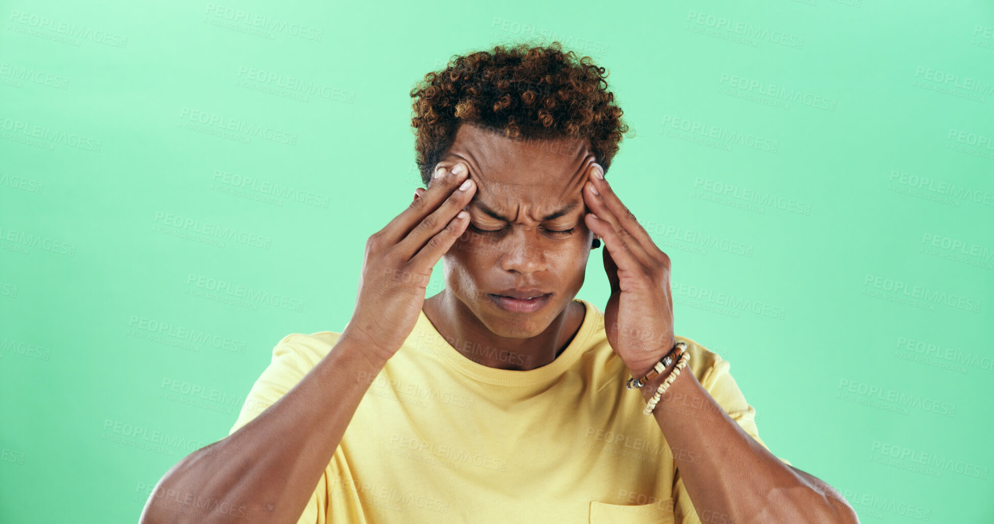 Buy stock photo Frustrated man, headache and stress with green background for injury or anxiety in studio. Male person, model or pain with migraine or strain for mental health, depression or fatigue on mockup space