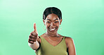 Black woman, thumbs up and portrait with happiness for support in studio, vote or review with gesture on green background. Hand, yes sign or signal with emoji, female person and feedback by space