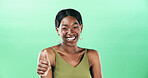 Woman, thumbs up and portrait with happiness for support in studio, vote or review with gesture on green background. Hand, yes sign or signal with emoji, African female person and feedback by space