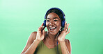 Music, smile and headphones with black woman in studio for streaming, audio playlist and song. Performance, sound and dancing with female person on green background for entertainment and space