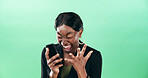 Happy, black woman and screaming with phone for good news or winning on a green studio background. Female person, employee or winner shouting with surprise on mobile smartphone for bonus or promotion