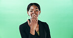 Black woman, portrait and blowing with kiss on green background for love or care in studio. Face, female person or model with romantic gesture for affection, distance or kindness on mockup space