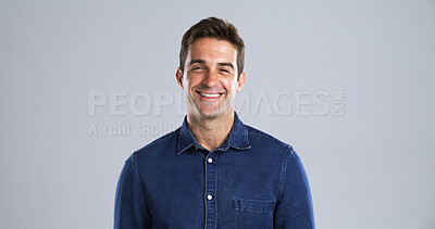 Buy stock photo Portrait, laughing and man in studio, smile and humor with positive mindset on gray background. Face, happy person and model with confident personality, space and funny with fun attitude and pride