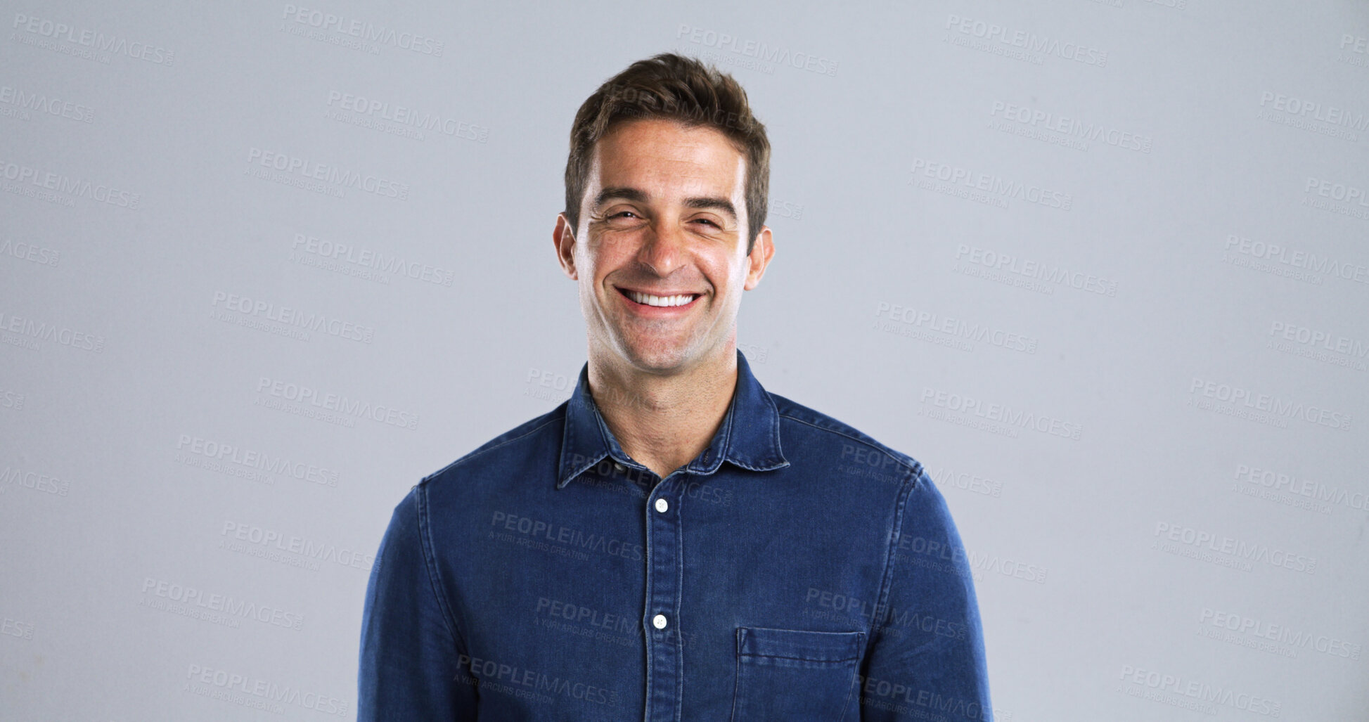 Buy stock photo Portrait, laughing and man in studio, smile and humor with positive mindset on gray background. Face, happy person and model with confident personality, space and funny with fun attitude and pride