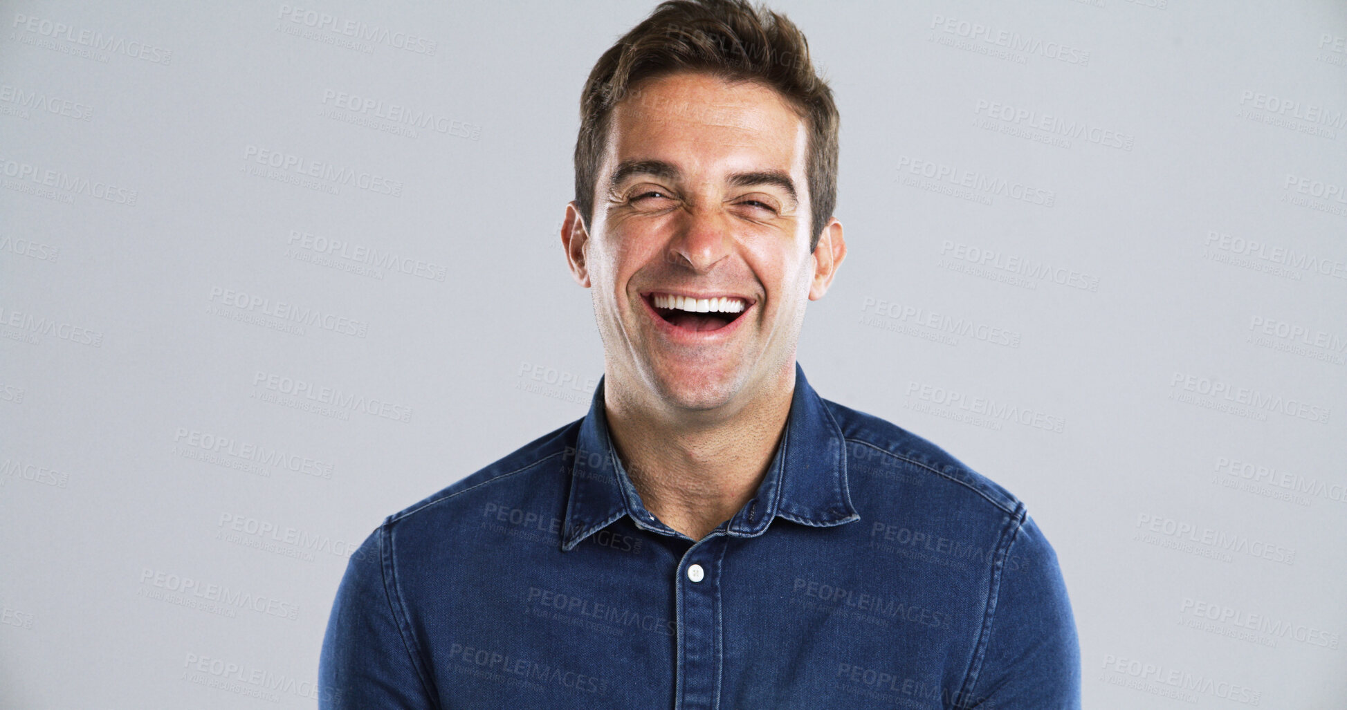 Buy stock photo Portrait, funny and man in studio, smile and humor with positive mindset on gray background space. Face, happy person or model with confident personality, joke and laughing with comic or fun attitude