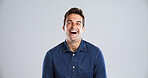 Portrait, funny and man in studio, humor and laughing with positive mindset on gray background. Face, happy person and model with confident personality, joke and smile with space and fun attitude