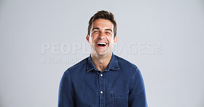 Buy stock photo Portrait, funny and man in studio, humor and laughing with positive mindset on gray background space. Face, happy person or model with confident personality, joke or smile with space and fun attitude