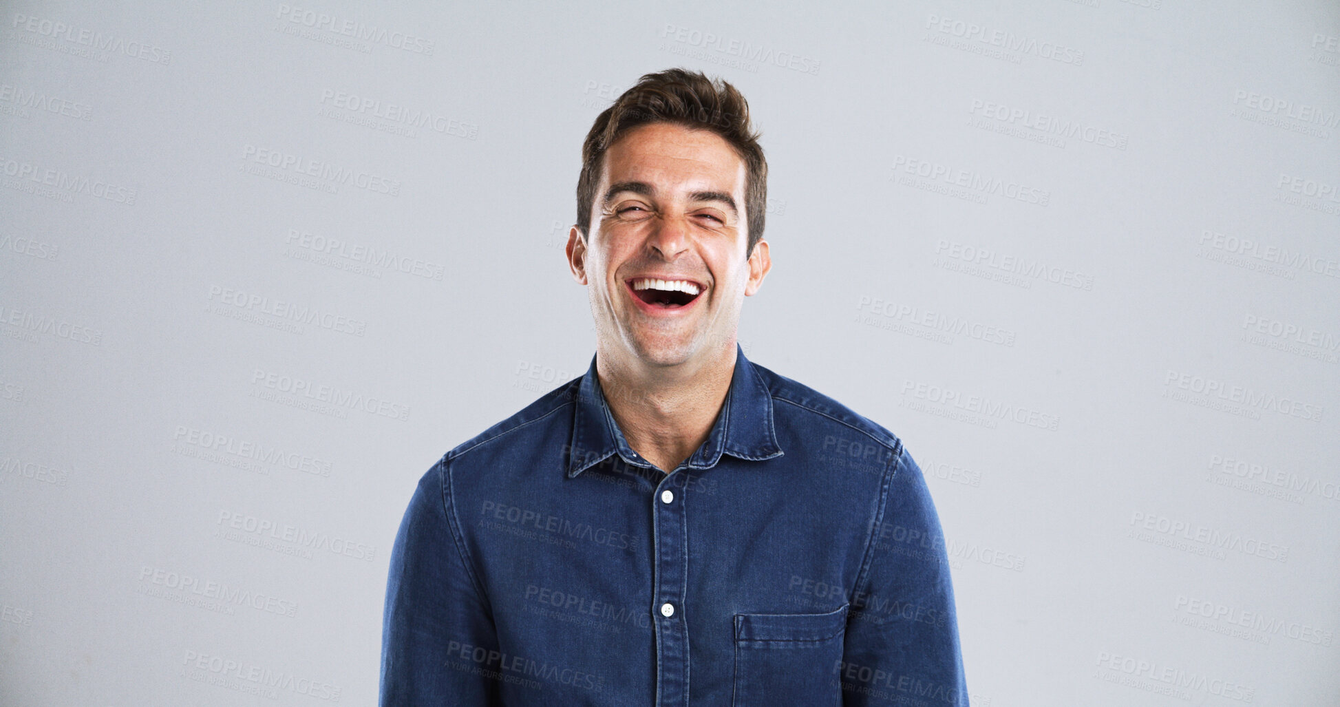 Buy stock photo Portrait, funny and man in studio, humor and laughing with positive mindset on gray background space. Face, happy person or model with confident personality, joke or smile with space and fun attitude