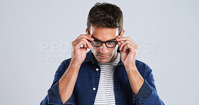 Buy stock photo Man, glasses and touch in studio for vision, optometry or adjusting to new lens for sight. Person, prescription specs and testing on white background space for eye care, designer frames or healthcare
