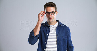 Buy stock photo Man, glasses and portrait in studio for optometry, vision or adjusting to new lens for sight. Person, prescription specs or touch on white background space for eye care, designer frames or healthcare