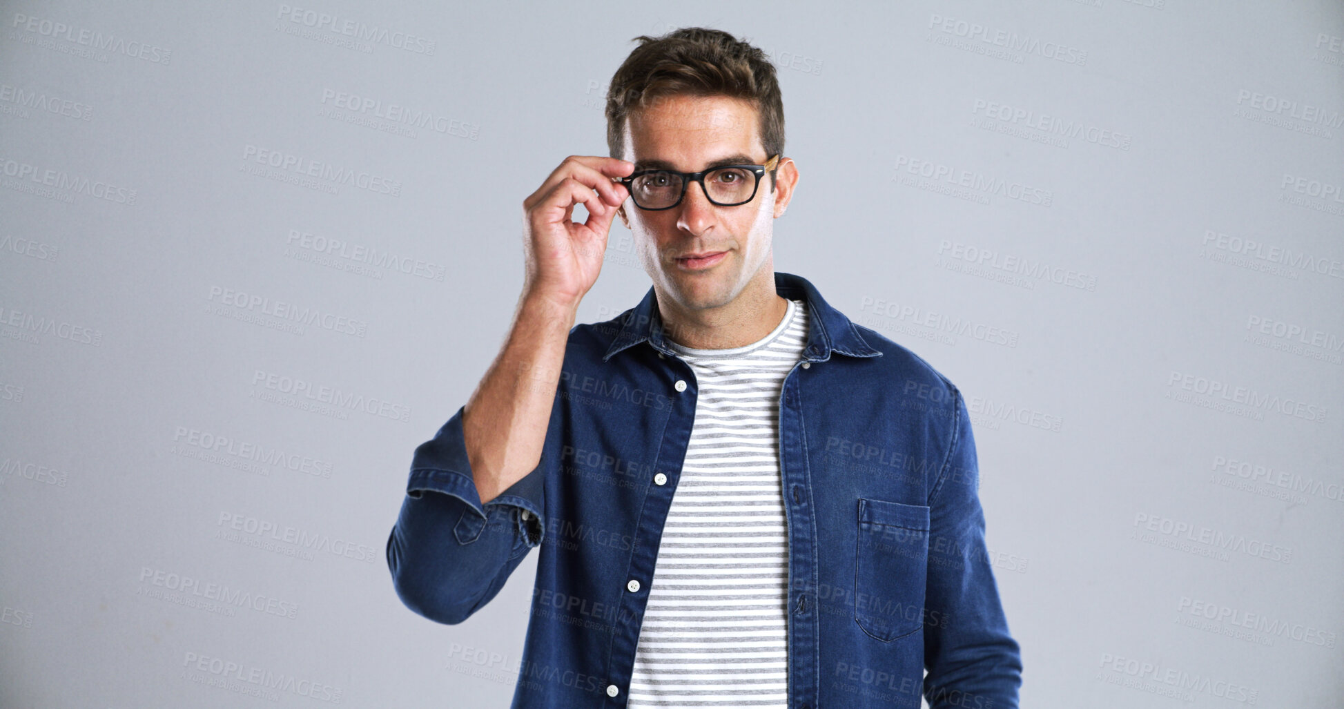Buy stock photo Man, glasses and portrait in studio for optometry, vision or adjusting to new lens for sight. Person, prescription specs or touch on white background space for eye care, designer frames or healthcare