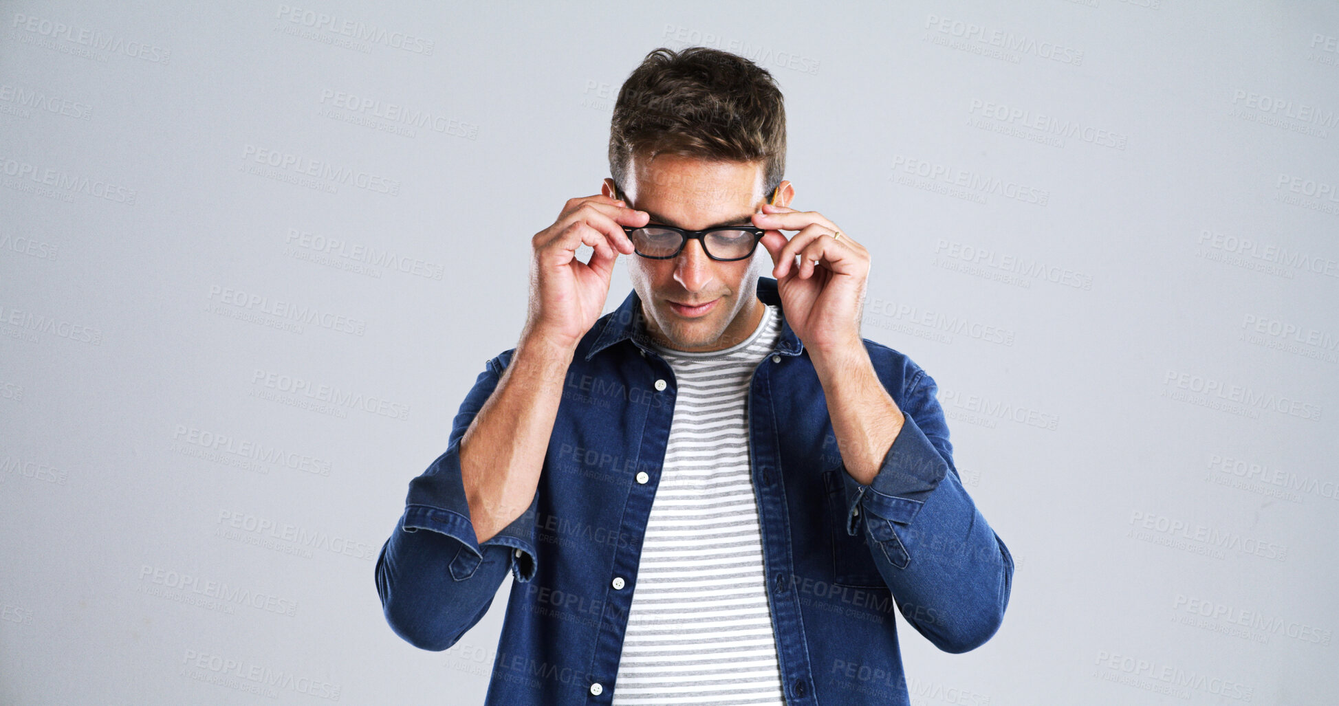 Buy stock photo Man, glasses and touch in studio for optometry, vision or adjusting to new lens for sight. Person, prescription specs and testing on white background space for eye care, designer frames or healthcare