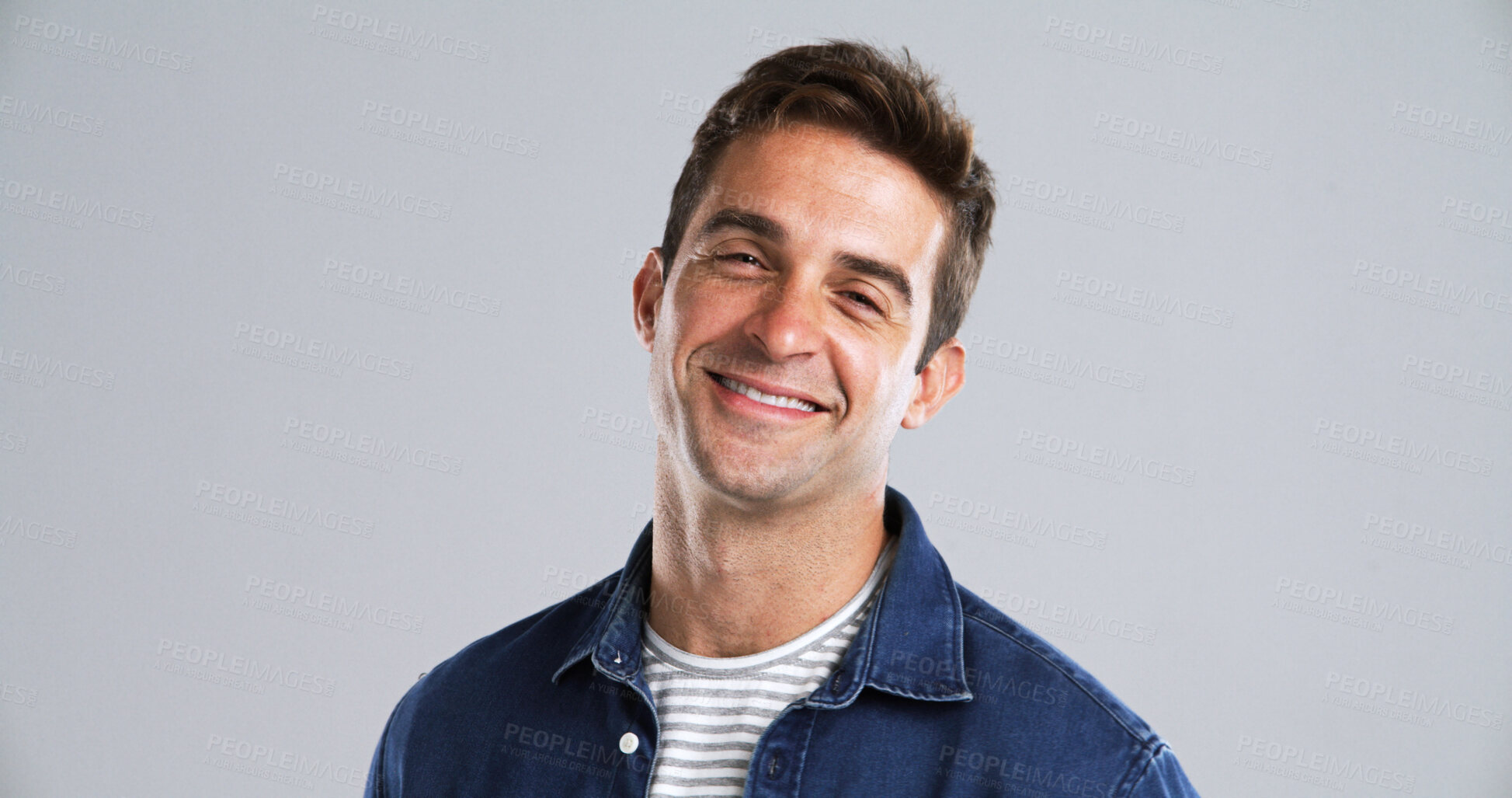 Buy stock photo Portrait, man and smile for fashion in studio with casual clothes, trendy style and positive attitude. Mockup, happy and male person with cool outfit, denim jacket and good mood on gray background 