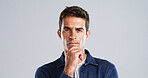 Portrait, man and thinking of solution in studio for problem solving, decision doubt and fake news. Mockup space, person and contemplating with question, confused and uncertainty on gray background