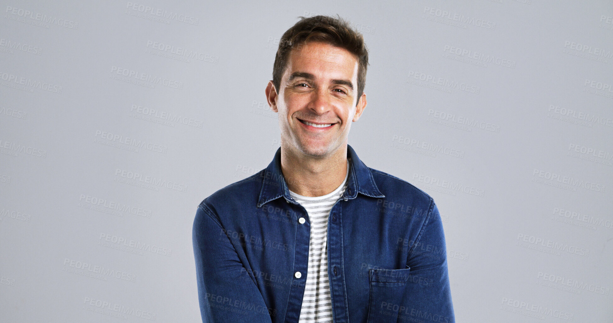Buy stock photo Portrait, man and smile with pride for fashion with casual clothes, trendy style and studio. Mockup, happy and male person with cool outfit, denim jacket and positive attitude on gray background 