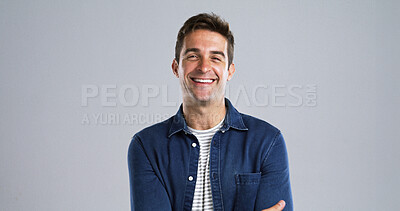 Buy stock photo Creative, happy man or portrait with confidence or positive attitude in studio on a gray background. Male person, model or designer with smile in denim jacket for fashion or style on mockup space