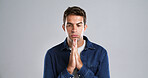 Man, prayer and worry in studio with faith, question or connection with Jesus Christ by background. Person, stress and reflection for religion, anxiety or spiritual worship for God with mock up space