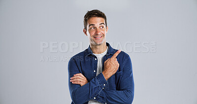 Buy stock photo Pointing, thinking and man in studio, promotion and announcement on gray background. Solution, mockup space and model with hand gesture, smile and discount deal with sales, decision and opportunity