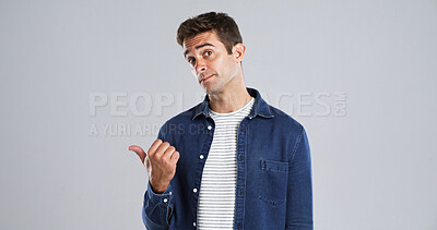 Buy stock photo Pointing, mockup space and portrait of man in studio with decision, opinion or news announcement. Choice, direction and male person from London with presentation hand gesture by white background.