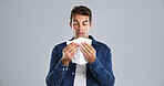 Sick man, sinus and blowing nose with tissue in studio for cold or infection on a gray background. Male person, model or influenza with toilet paper or allergy for hayfever or illness on mockup space