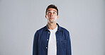 Man, thinking and curious for choice in studio by listening to gossip, hear rumor and fake news. Mockup space, person and spying for information, suspicious and interesting story on white background
