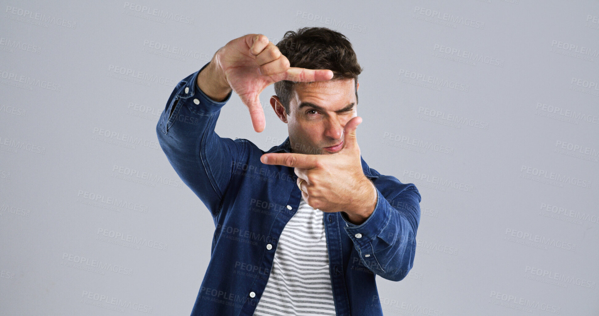 Buy stock photo Studio, portrait and man with frame, confident or border with hands for photography or mockup space. White background, fashion and person with pride for post, social media or sign for profile picture