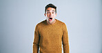 Portrait, man and shocked with fear in studio for bad news, drama and reaction to danger risk. Mockup space, person and surprise expression for horror story, scary rumor and terror on gray background