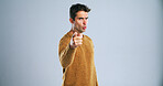 Angry, pointing and portrait of man in studio for blame, scolding or discipline with education conflict. Strict, finger wag and male teacher upset for wrong, mistake or failure by gray background.