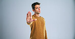 Man, portrait and stop with palm in studio for rejection, no or halt on a white background. Male person, model or disapproval with hand out for warning, termination or cease fire on mockup space