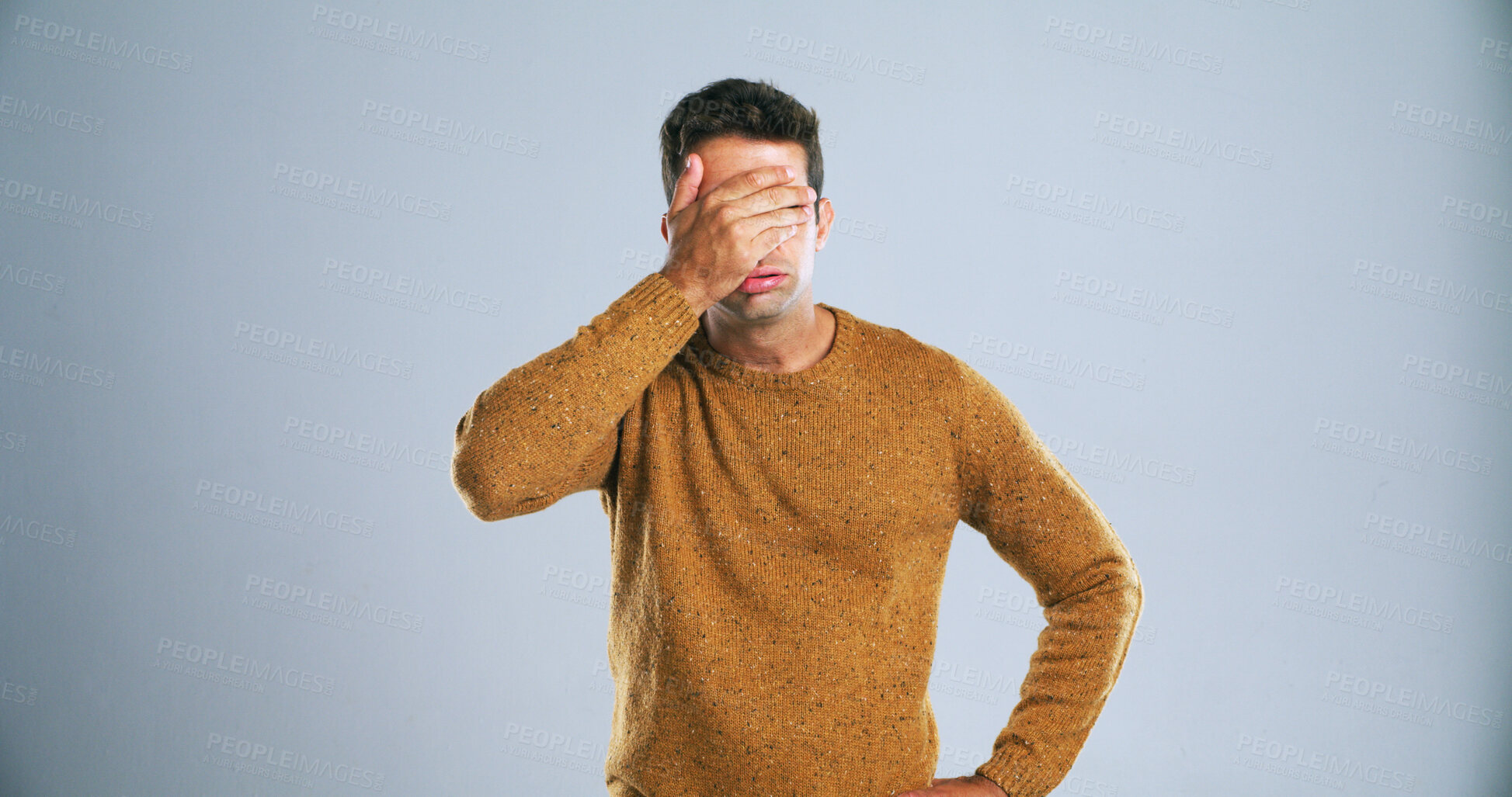 Buy stock photo Frustrated, upset and man with hand on face in studio for mistake, disappointment or fail. Stress, anxiety and male person with shame for bad decision, choice or fake news by gray background.
