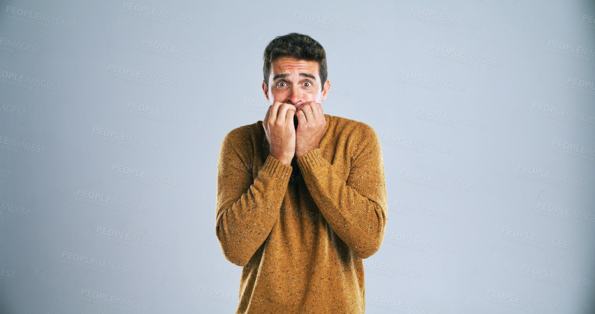 Buy stock photo Nervous, portrait or man with nail bite in studio for anxiety, fear or stress on a white background. Scared, male person or model in terror for mental health, overwhelmed or intense on mockup space