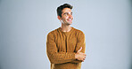 Smile, man and pride for fashion in studio with winter jersey, casual clothes and cool style. Mockup space, thinking and person with arms crossed for confidence, trendy outfit and white background