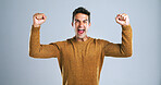 Man, scream and fist pump in studio portrait with celebration, success and goals by background. Person, winner and excited with smile, shout and competition with giveaway, cheers and profit in Spain