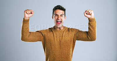 Buy stock photo Man, scream and fist pump in studio portrait with celebration, success and goals by background. Person, winner and excited with smile, shout and competition with giveaway, cheers and profit in Spain