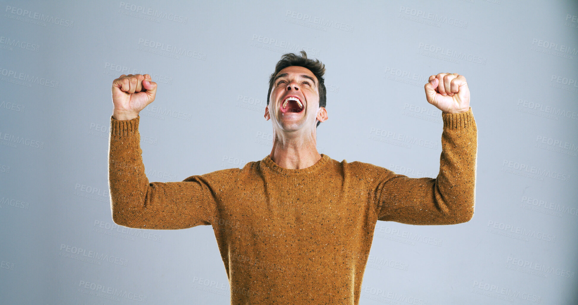 Buy stock photo Happy man, fist pump or celebration in studio for winning, victory or bonus on a white background. Excited, male person or model shouting in joy with relief for achievement, promotion or winner prize