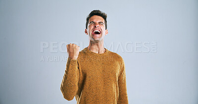 Buy stock photo Man, celebration and fist pump in studio with shout, success and finance goals by background. Person, winner and excited with eyes closed, scream and mock up space for investment, revenue and profit
