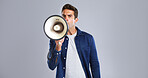 Portrait, megaphone and man in studio, screaming or justice with protest on white background. Facial expression, person or model with bullhorn, frustrated or activism for human rights, noise or angry