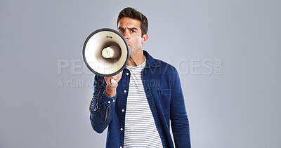 Buy stock photo Portrait, megaphone and man in studio, screaming or justice with protest on white background. Facial expression, person or model with bullhorn, frustrated or activism for human rights, noise or angry