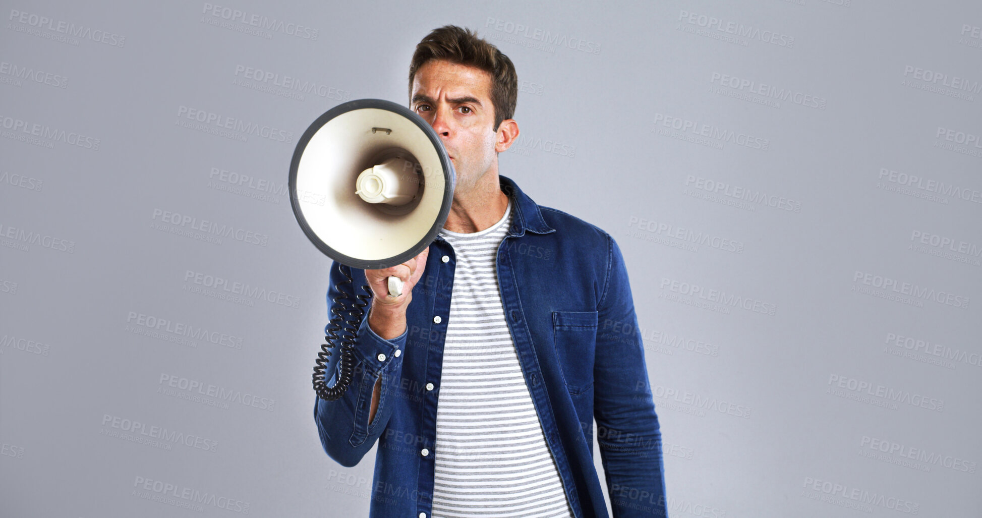 Buy stock photo Portrait, megaphone and man in studio, screaming or justice with protest on white background. Facial expression, person or model with bullhorn, frustrated or activism for human rights, noise or angry